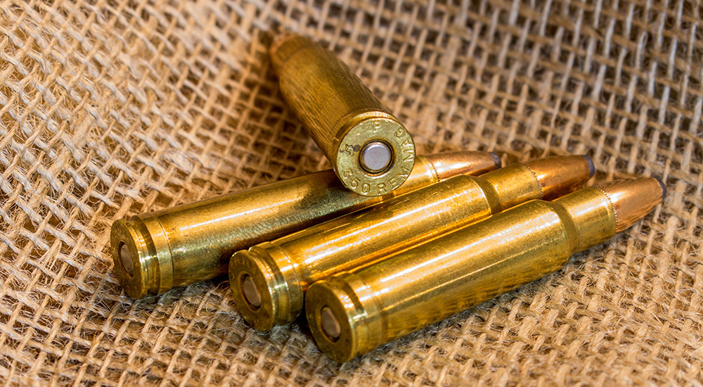 350 Remington Magnum ammunition cartridges on burlap.
