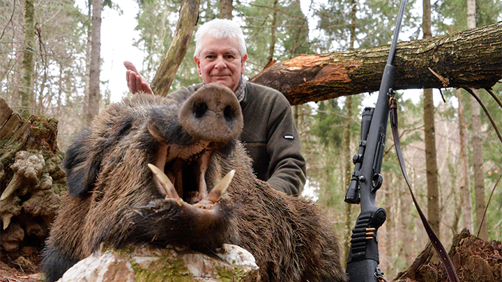 Hunter with wild boar in France