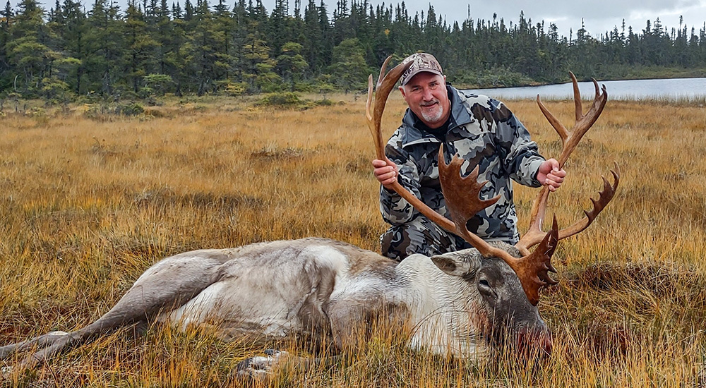 Hunter with Woodland caribou in Newfoundland, Canada