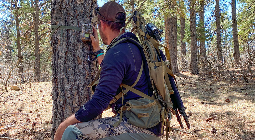 Hunter Checking Trail Camera
