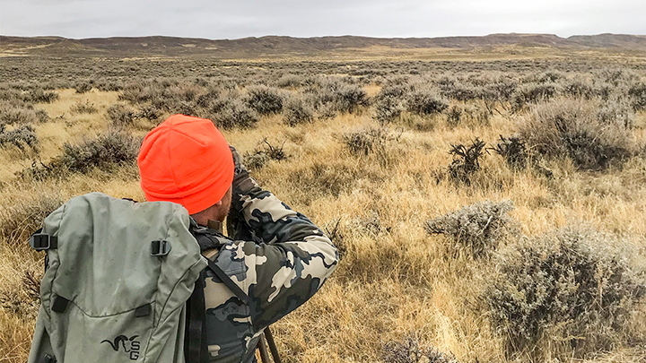 Hunter Looking Through Binocular in Wyoming in Search of Pronghorn