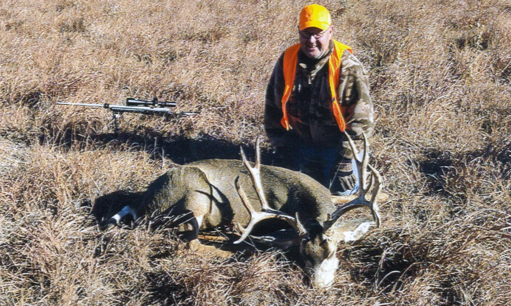 Hunter with Mule Deer buck