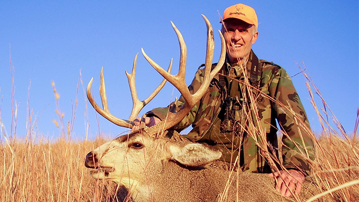 Hunter with mule deer buck in Nebraska