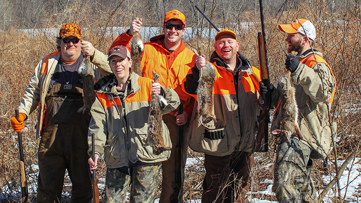 Group of Small-Game Hunters Holding Rabbits