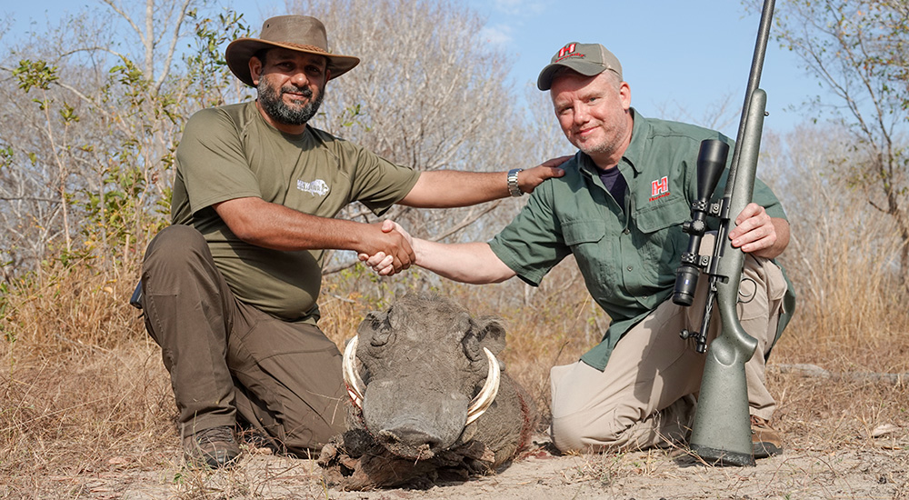 Two males with warthog.