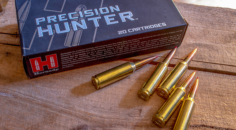 Hornady Precision Hunter 6.5 PRC ammunition on wooden table.