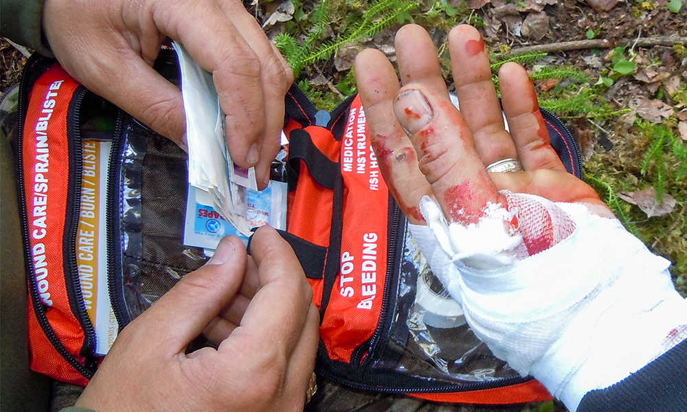 Using First Aid Kit to Dress Hand Wound in Wilderness