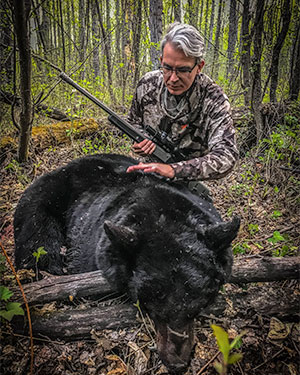 hunter with black bear