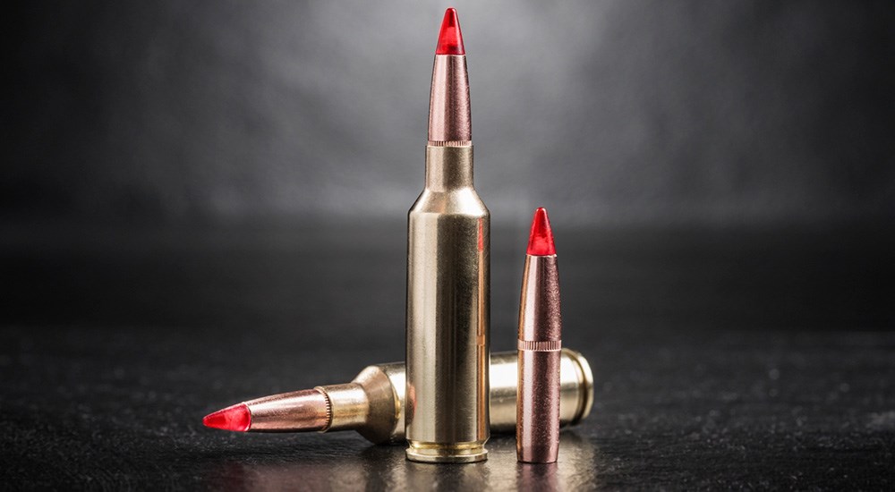 Winchester 6.8 Western Copper Impact Ammunition on black studio backdrop.