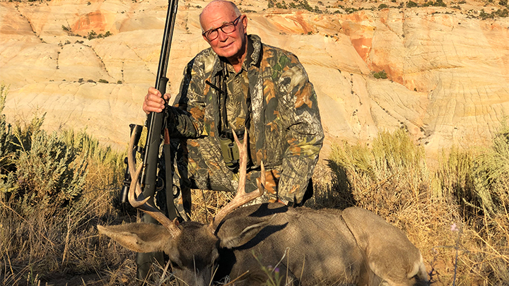 Hunter with mule deer buck