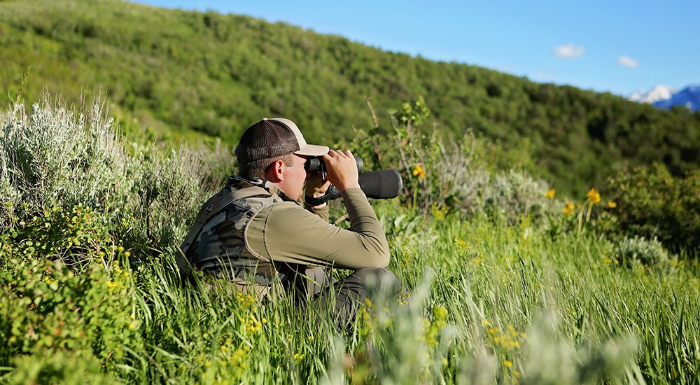 Hunter Looking through a Spotting Scope for Game