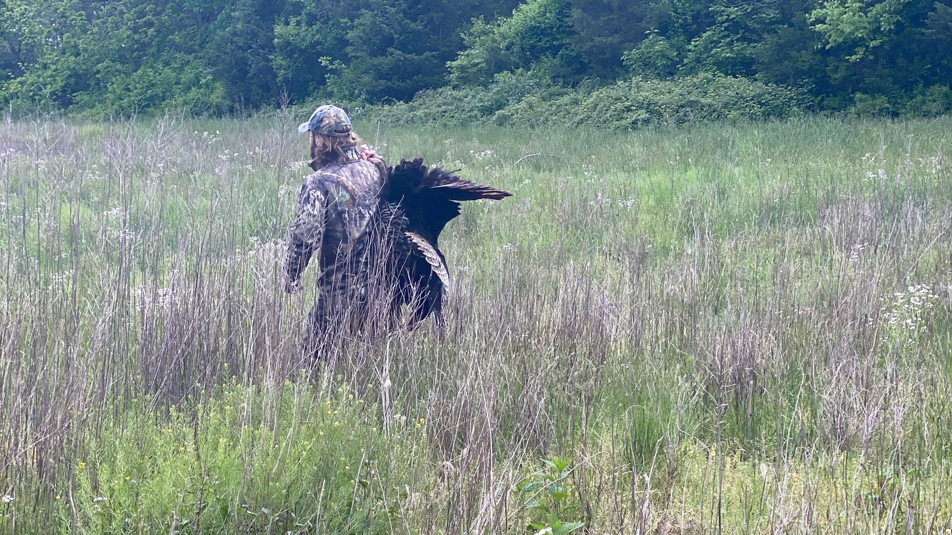 Herman walking out of field with turkey