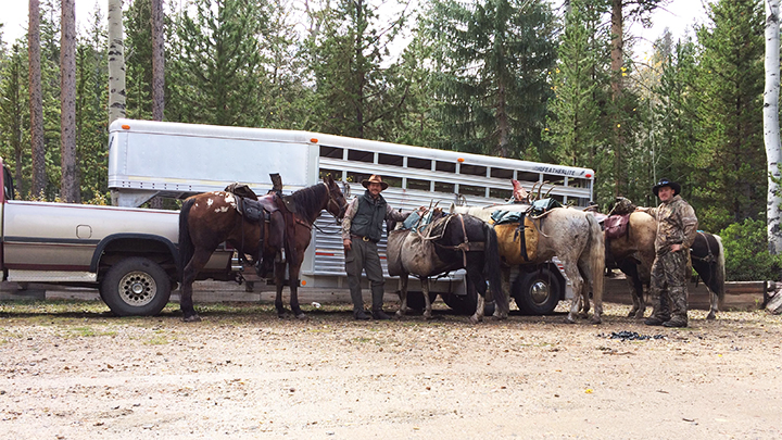 Hunters with Horses in front of Horse Trailer