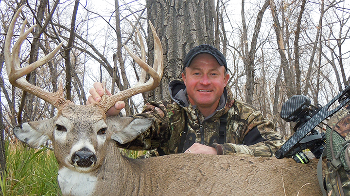 Hunter with Whitetail Buck