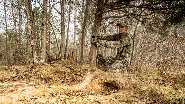 Hunter Checking Trail Camera Photos