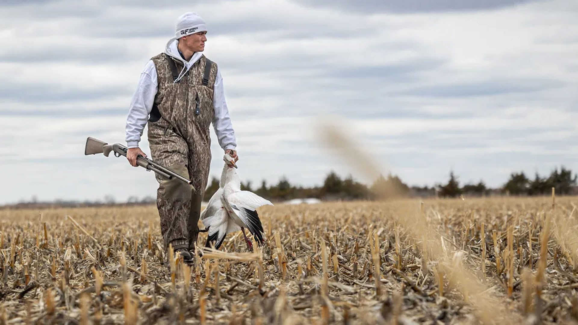 Man Walking with shotgun and snow goose