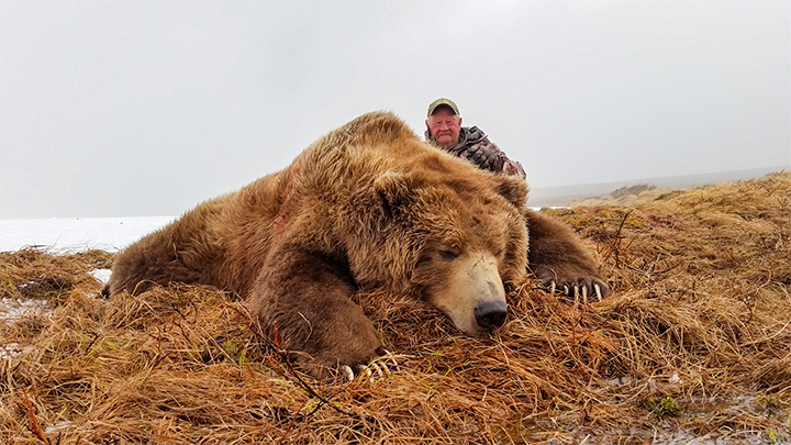 Hunter with coastal brown bear taken on the Katmai Preserve in Alaska