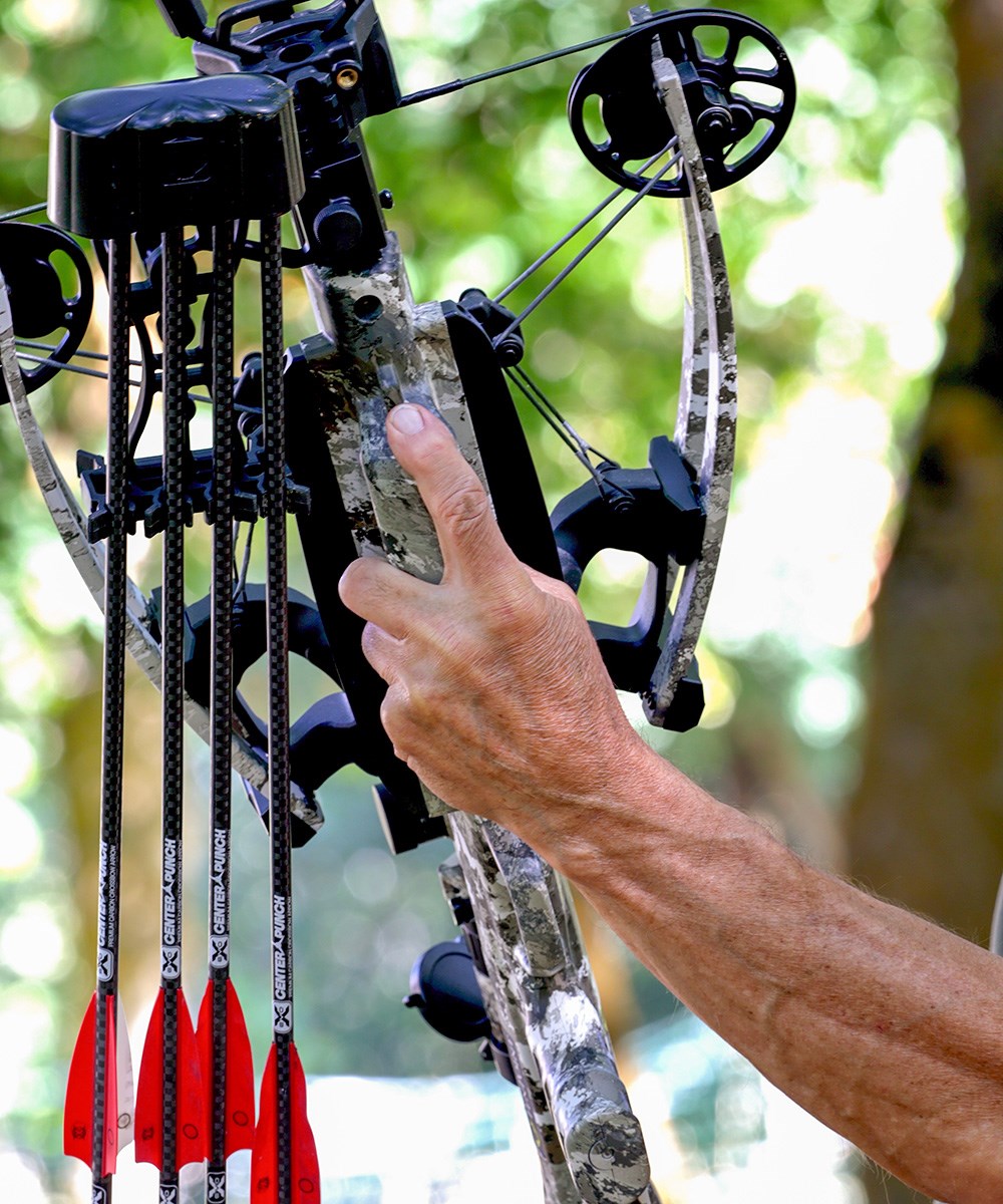 Male holding up TenPoint crossbow to show scale of size.