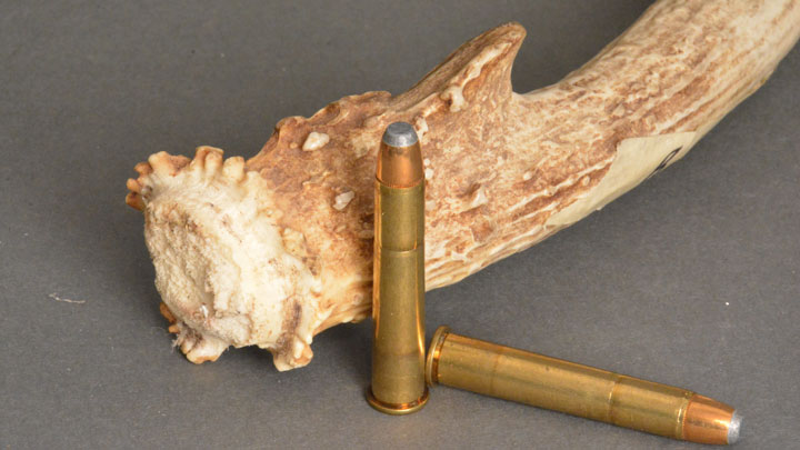 Two cartridges sitting next to the base of a shed antler
