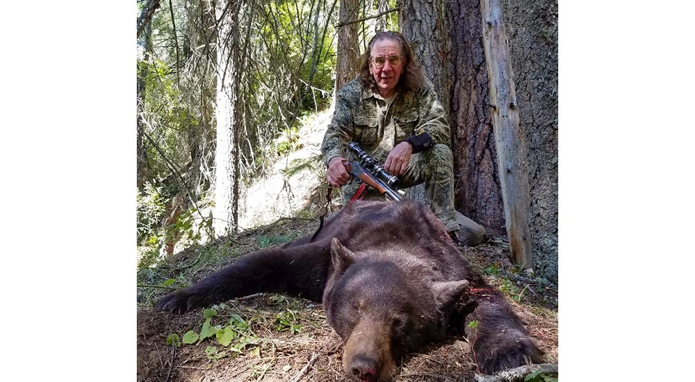 Hunter with black bear in Idaho
