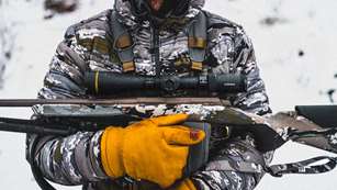 Man Holding Rifle Lede