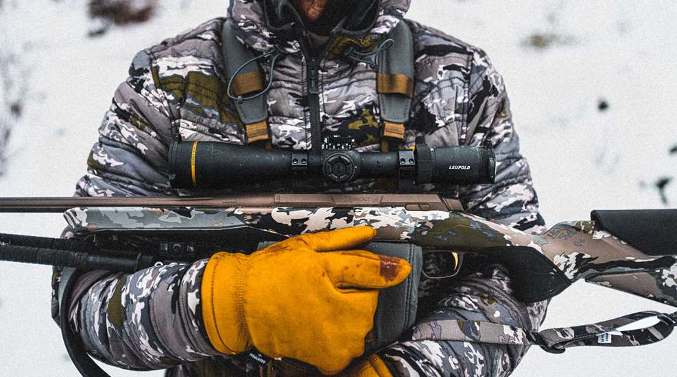 Man Holding Rifle Lede