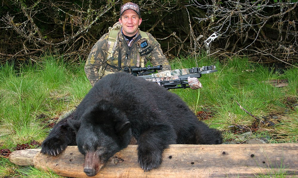 Male hunter posing with spring black bear.