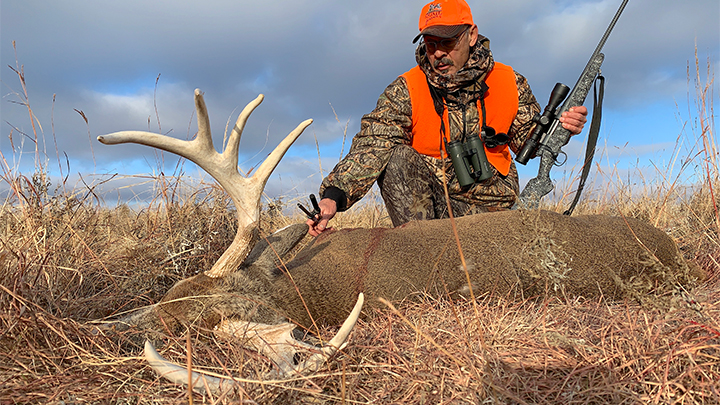Hunter with 10-point whitetail buck taken on public land