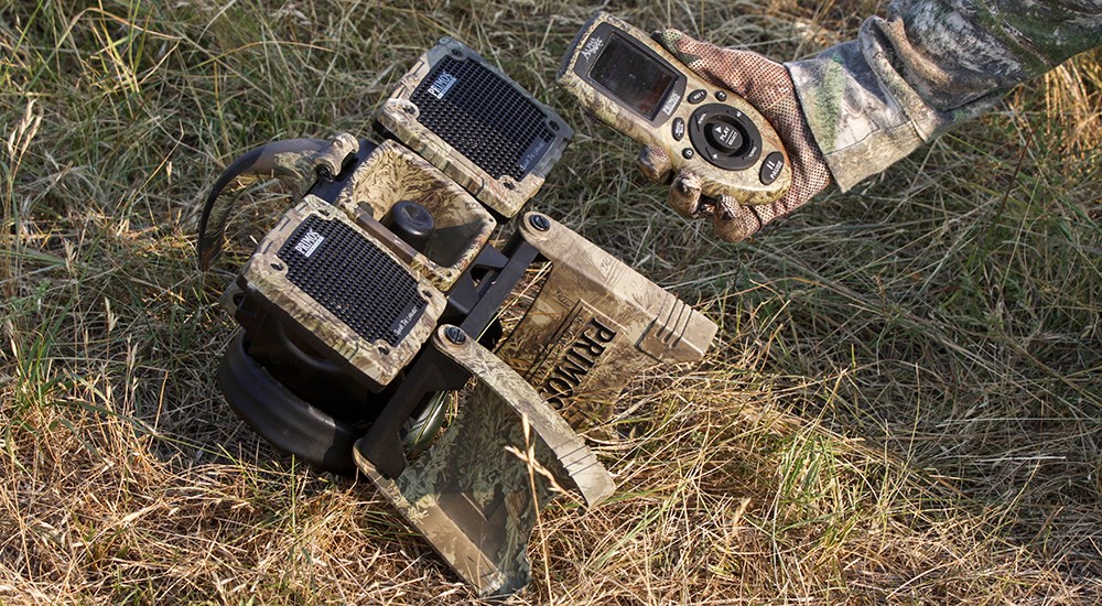 Primos electronic predator caller laying on grass field.