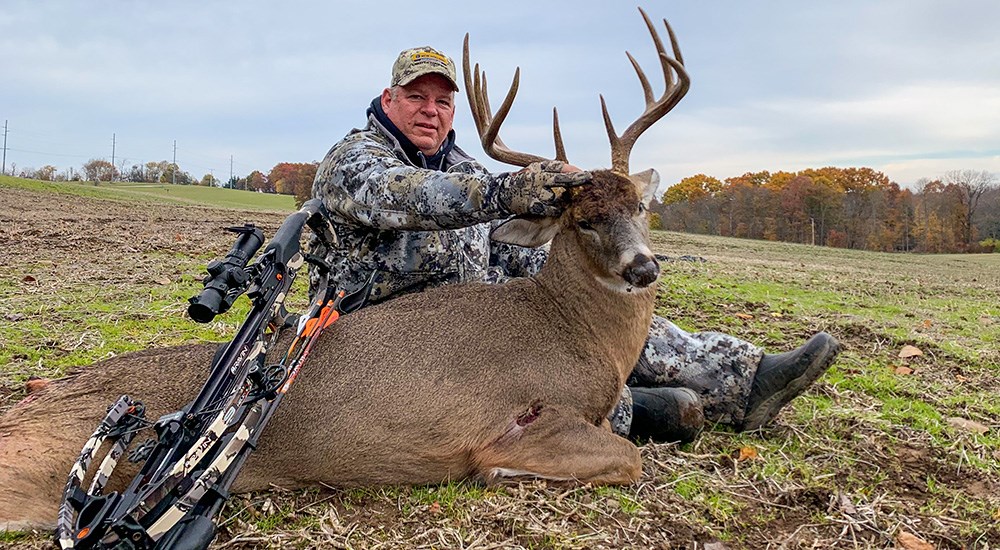 Hunter with whitetail buck in Ohio