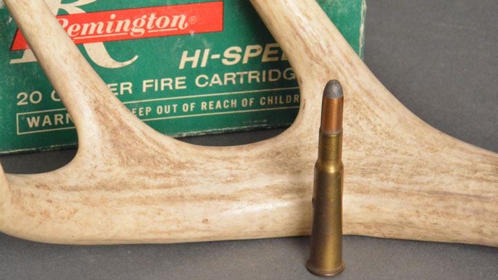 .30-40 Krag cartridge sitting next to deer antler, with green box in the background.