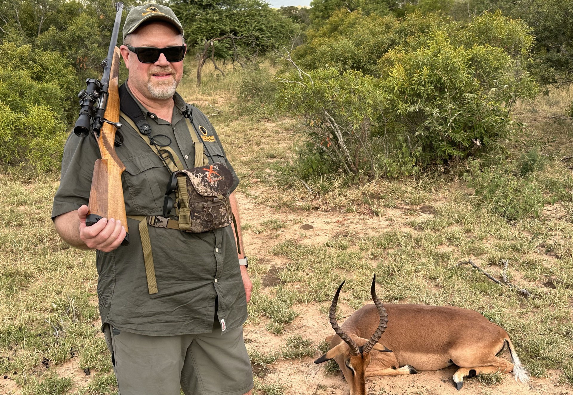 Hunter with rifle and animal