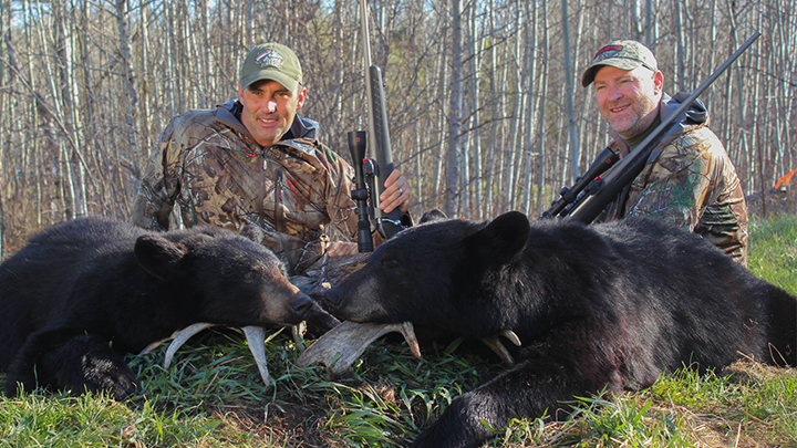 Two Hunters with Black Bears