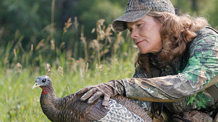 Female hunter setting hen decoy