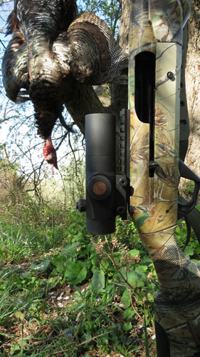 TruGlo Gobbler-Stopper with turkey hanging from tree in background