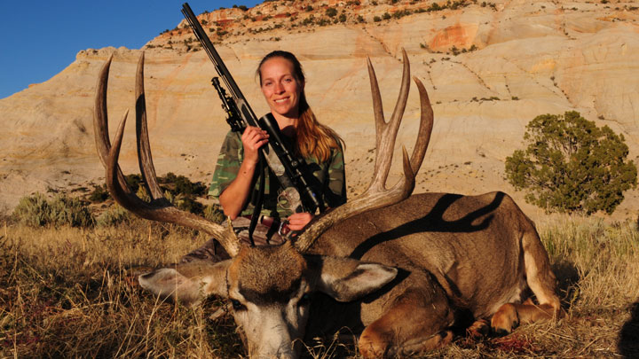 Huntress with downed mule deer