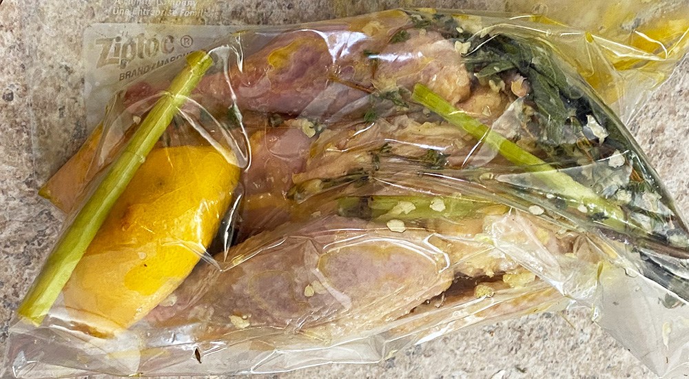 Fresh Herbs and Lemon Marinating Whole Plucked Pheasant