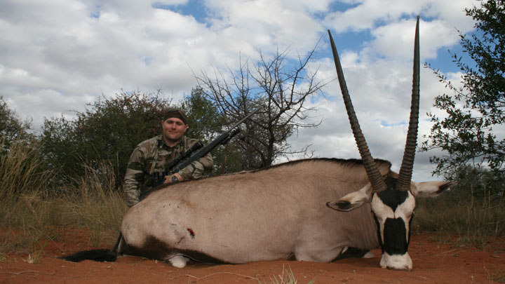 Hunter with a Nosler TGR and a  downed Gemsbock