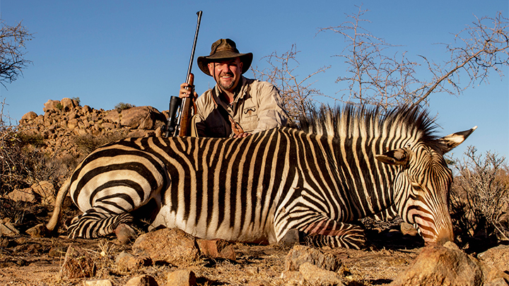 Hunter with Hartmann&#x27;s Mountain Zebra