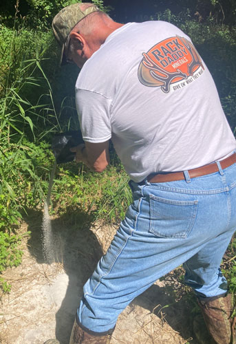 Mike pouring minerals to promote herd health