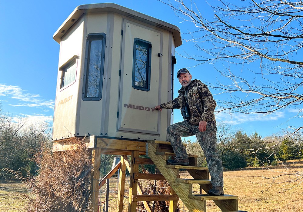 Male hunter walking into hunting blind.