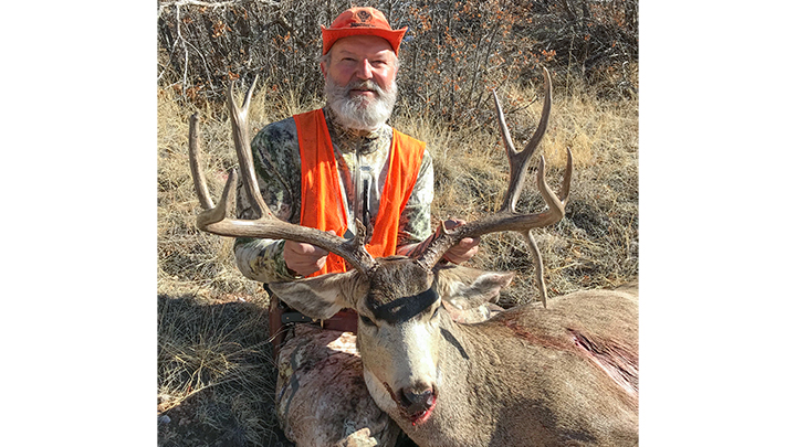 Hunter with mule deer buck taken in Game Management Unit 591 in Colorado