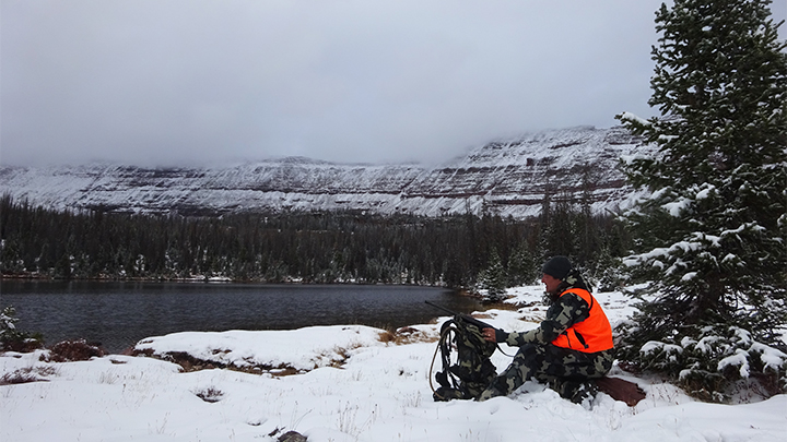 Hunter in mountains with orange vest