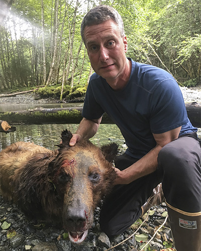 Man with brown bear