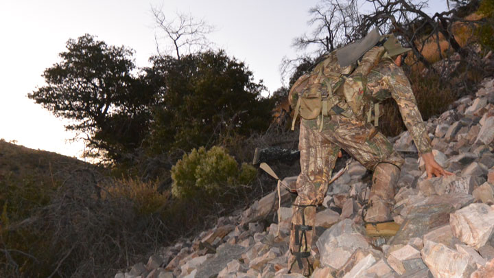 Hunter hiking up hillside