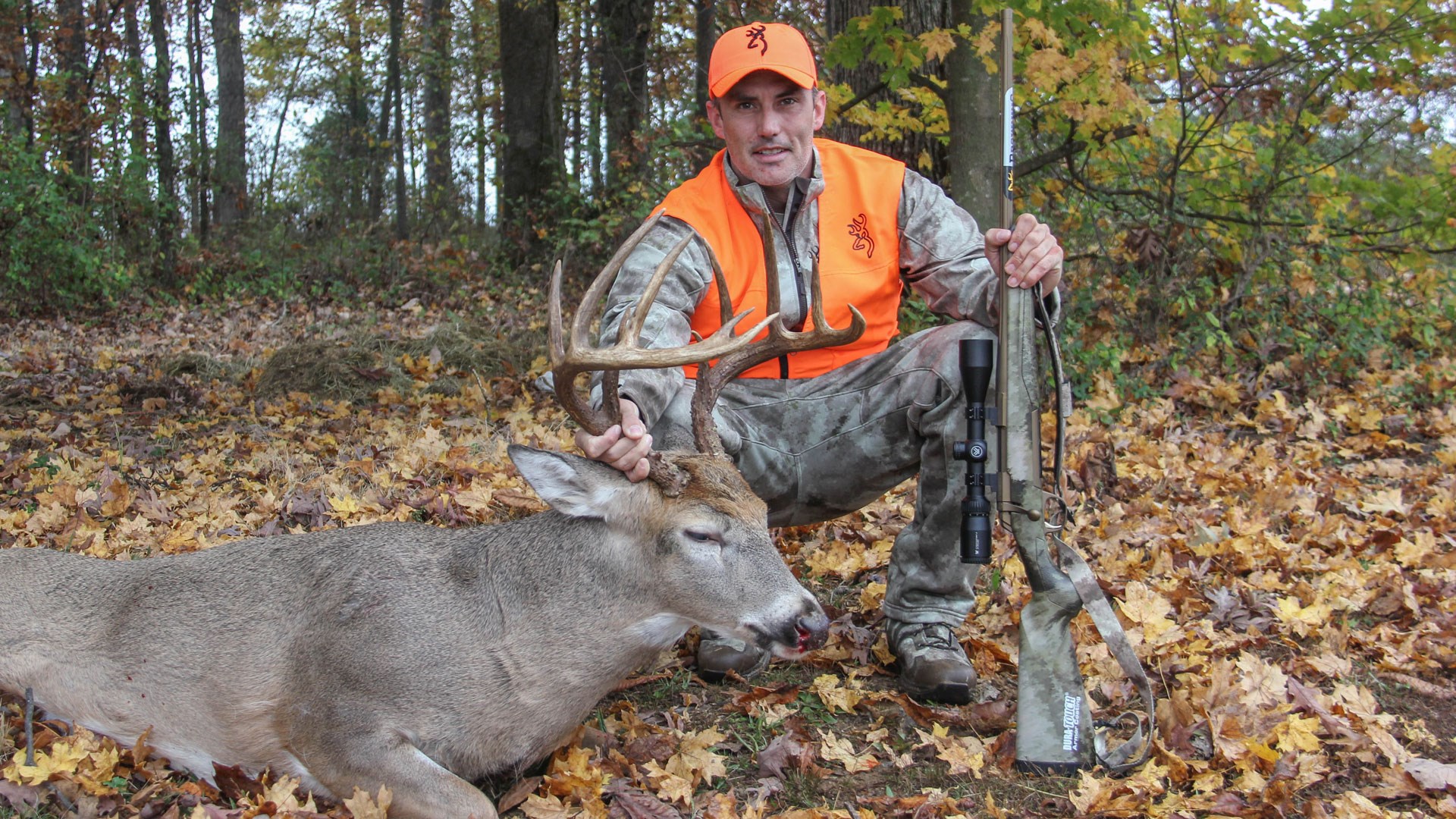 Hunter with deer and rifle