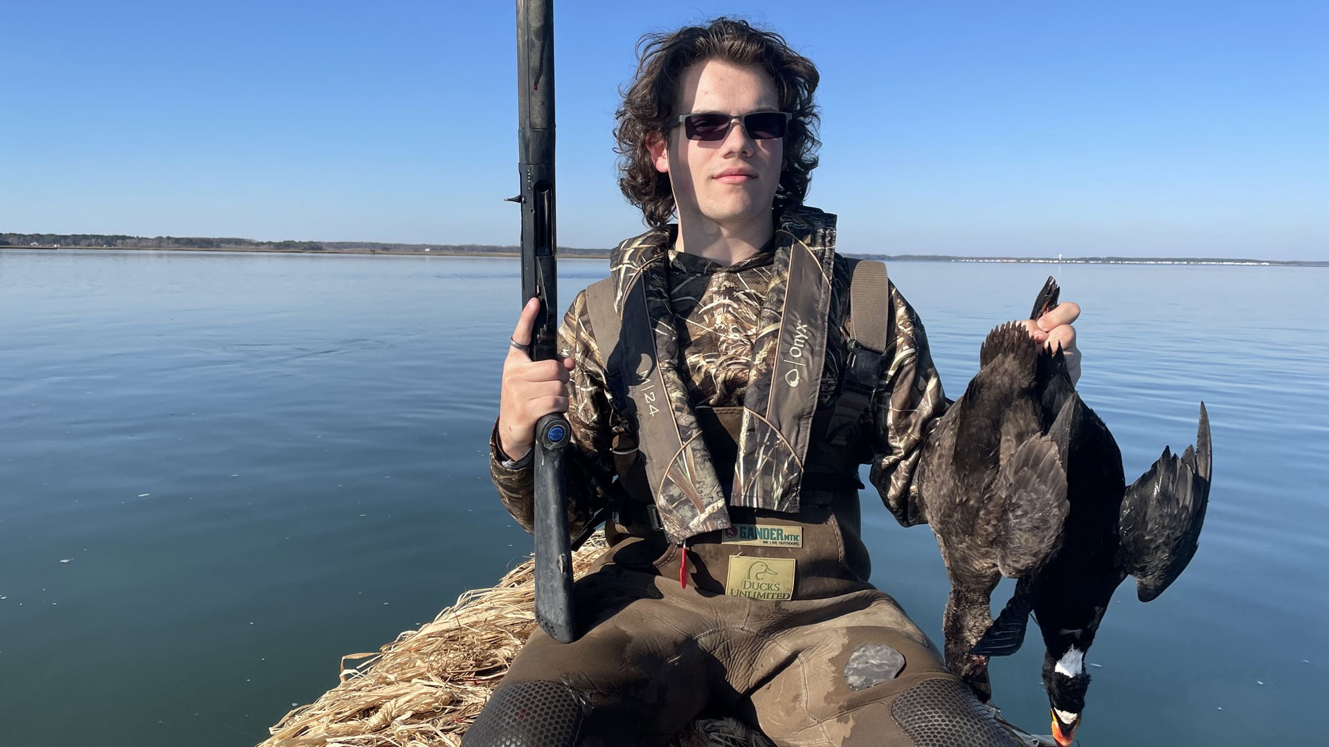 Hunter in boat with duck