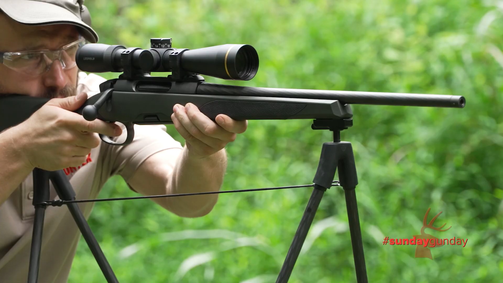 Spartan Precision Springbok quad sticks holding bolt-action rifle outdoors with man shooter on the gun #SUNDAYGUNDAY deer logo bottom right overlay
