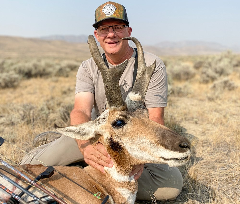 Hunter with pronghorn buck killed with bow