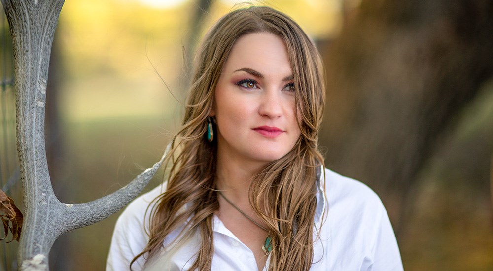 Portrait of brunette female with brown eyes.